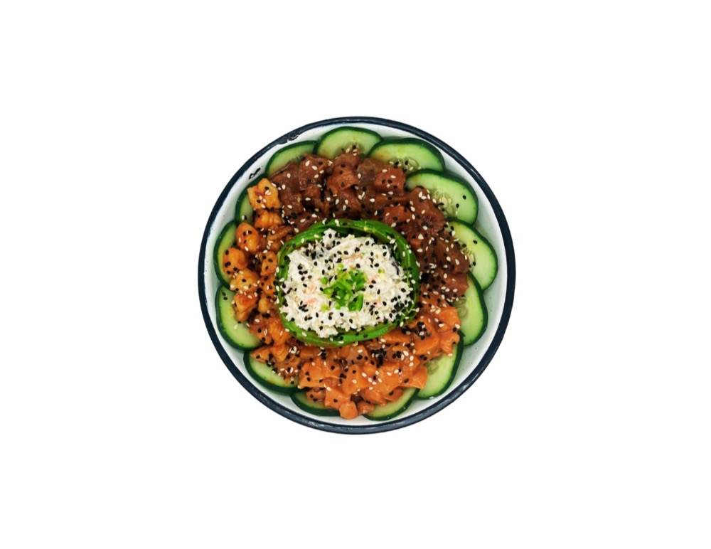 Diced raw fish and rice in a bowl ringed with cucumber slices, sesame seeds, and a garnish of chopped green onion.